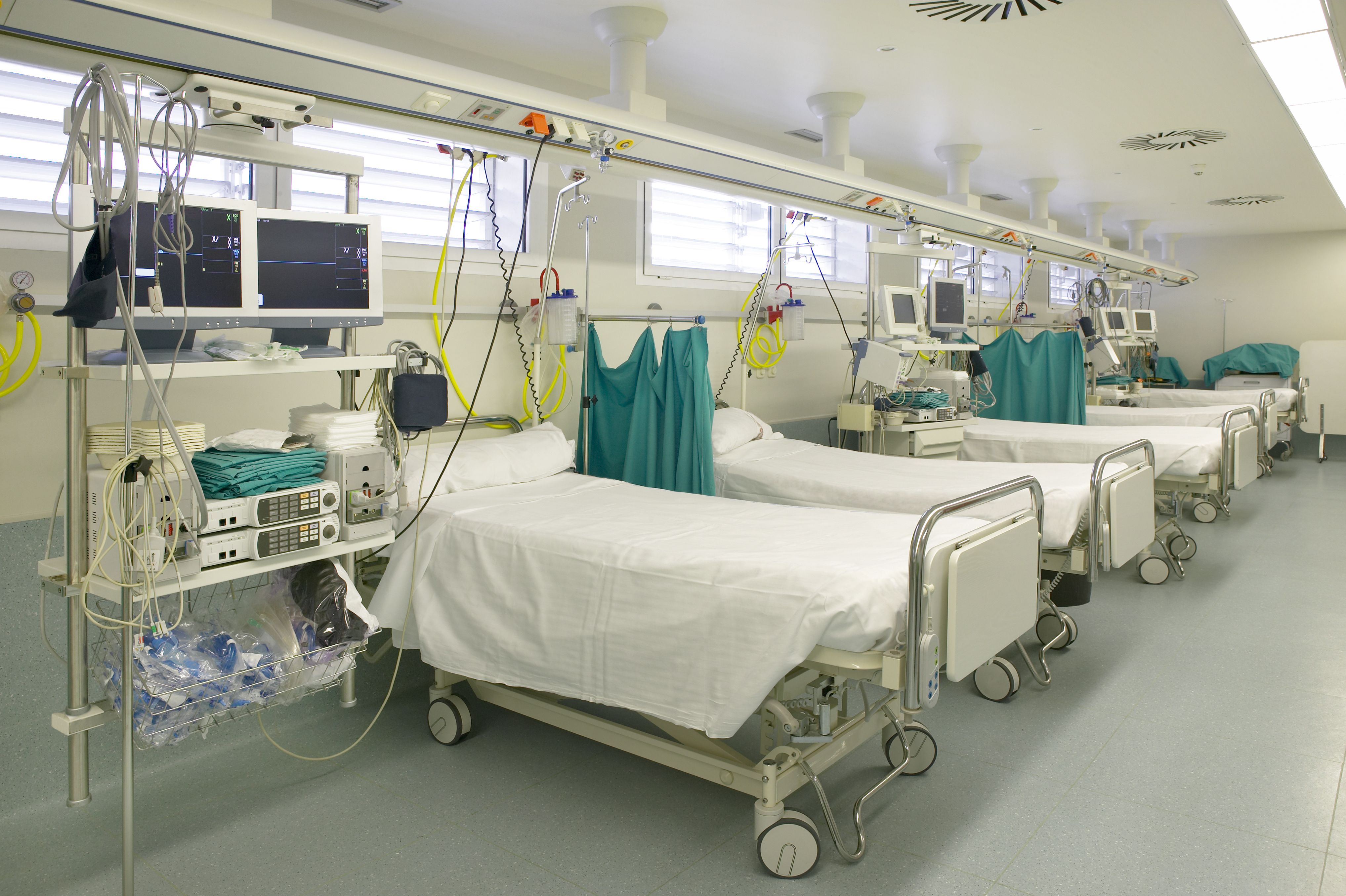 hospital intensive care unit area with beds equipment